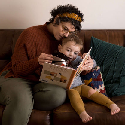 https://cdn.shopify.com/s/files/1/0005/3195/5769/files/LightoftheSaintsmotherreadingwithchild.jpg?v=1758317849