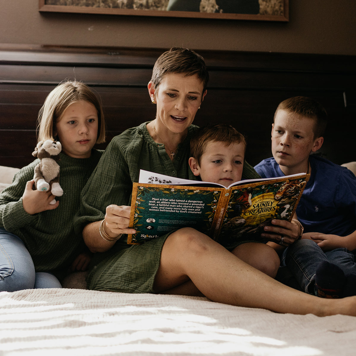 https://cdn.shopify.com/s/files/1/0005/3195/5769/files/SaintlyCreaturesFamilyReadingLifestyle2.jpg?v=1758317684