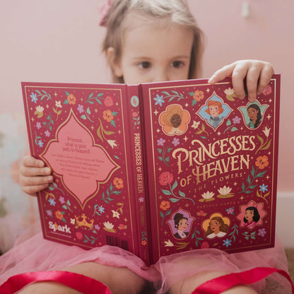 https://cdn.shopify.com/s/files/1/0005/3195/5769/files/princesses-of-heaven-reading-book-lifestyle_compressed.jpg?v=1758317474